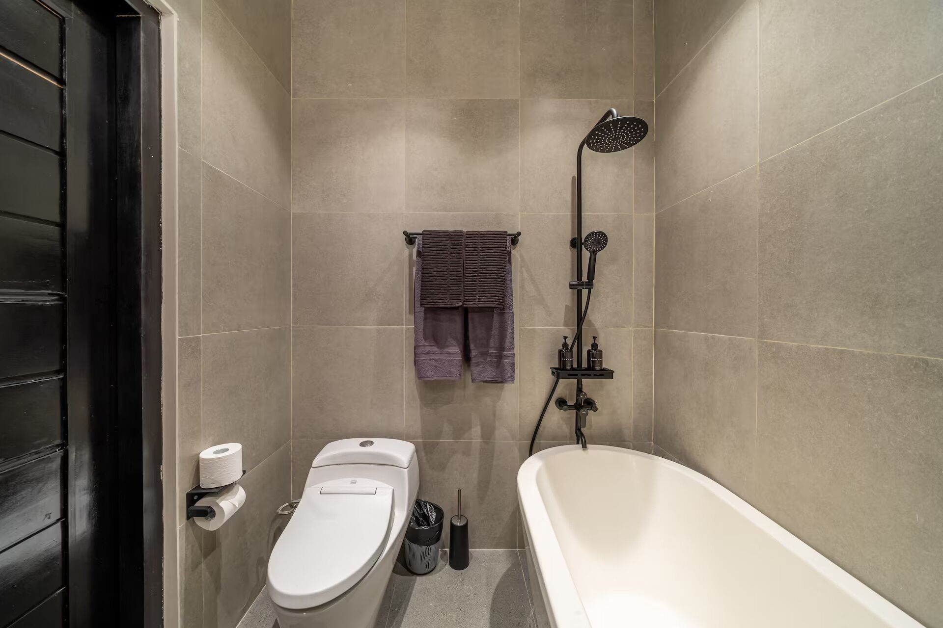 A bathroom with a toilet, a shower, and a bathtub.