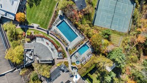 An aerial view of a property with a swimming pool, tennis court, and landscaped areas. - Topnotch Luxury Retreat | Sleeps 12 • Pet Friendly • Game Room (Stowe)