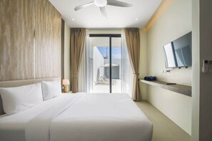 A hotel room with a bed, a ceiling fan, a TV mounted on the wall, and a view of the outside. - Brand new 3BR Pool Villa with Outdoor Dining (Si Sunthon)