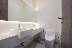 A modern bathroom with a double sink, a toilet, and a mirror. - Brand new 3BR Pool Villa with Outdoor Dining (Si Sunthon)