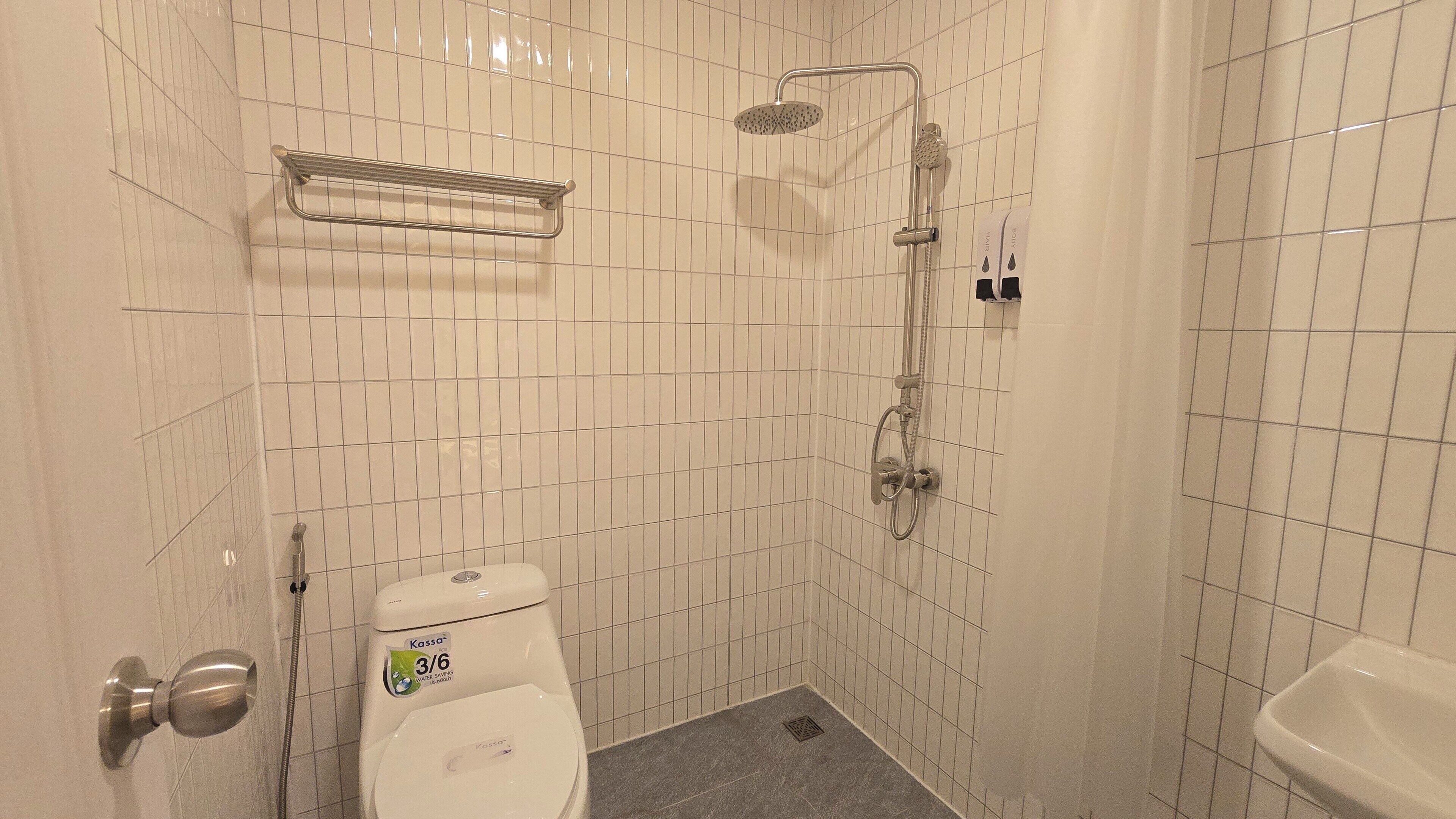 Ein kleines Badezimmer mit Toilette, Dusche und Waschbecken.