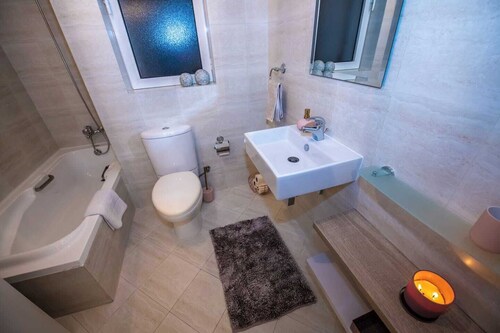 Relax in this stylish private maisonette in Mellieha, offering two bedrooms, a bright open-plan living space, kitchen, bathroom with bath, and a peaceful private backyard for morning coffee, family time, or evening drinks after relaxed beach days.