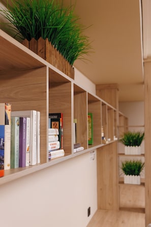 A bookshelf with books and plants.