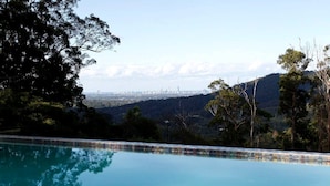 A swimming pool with a city skyline in the background. - Stunning Tree House with Pool Access Ideal for Luxury Holiday Accommodation, Gold Coast (Gold Coast)