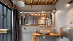 A compact bathroom with a wooden vanity, a stone sink, and a mirrored wall. - Stunning Tree House with Pool Access Ideal for Luxury Holiday Accommodation, Gold Coast (Gold Coast)