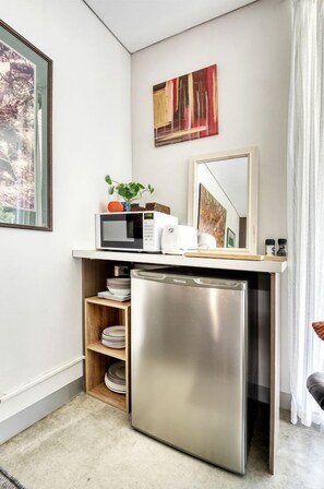 A compact kitchenette with a microwave, toaster, and small refrigerator. - Deluxe Beachside Cottage with Access to Venus Bay's Sandy Beaches in Victoria, Australia (Venus Bay)
