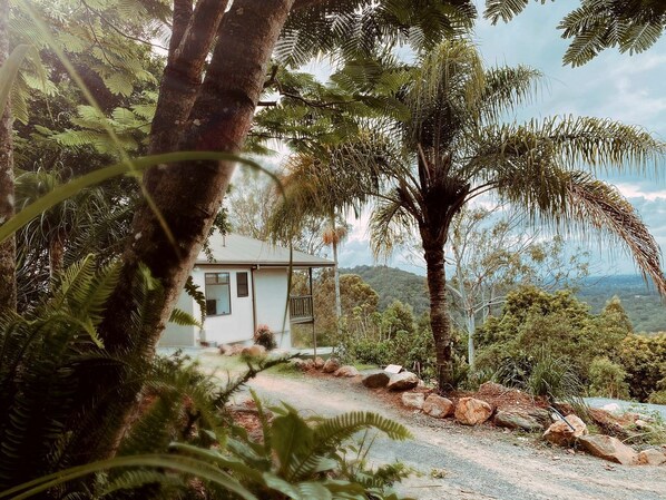 A house surrounded by natural scenery, including trees and a view of the landscape.