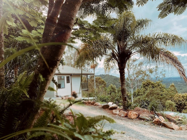 A house surrounded by natural scenery, including trees and a view of the landscape.