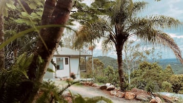 A house surrounded by natural scenery, including trees and a view of the landscape.