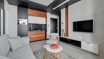 Deluxe Apartment, Balcony, Courtyard View | Living area | 40-inch flat-screen TV with cable channels