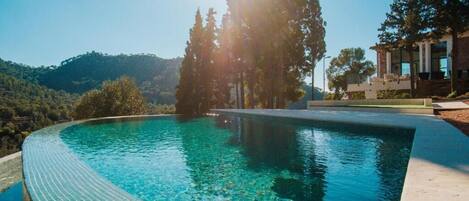 Seasonal outdoor pool, open 10:00 AM to 8:30 PM, pool umbrellas