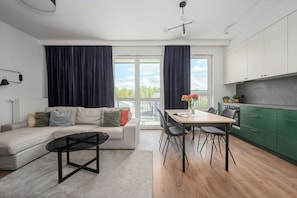 A modern apartment with a living area, dining space, and kitchen. - ShortStayPoland Budki Szczęśliwickie (Warszawa)