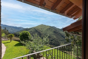 A balcony with a view of a mountainous landscape.