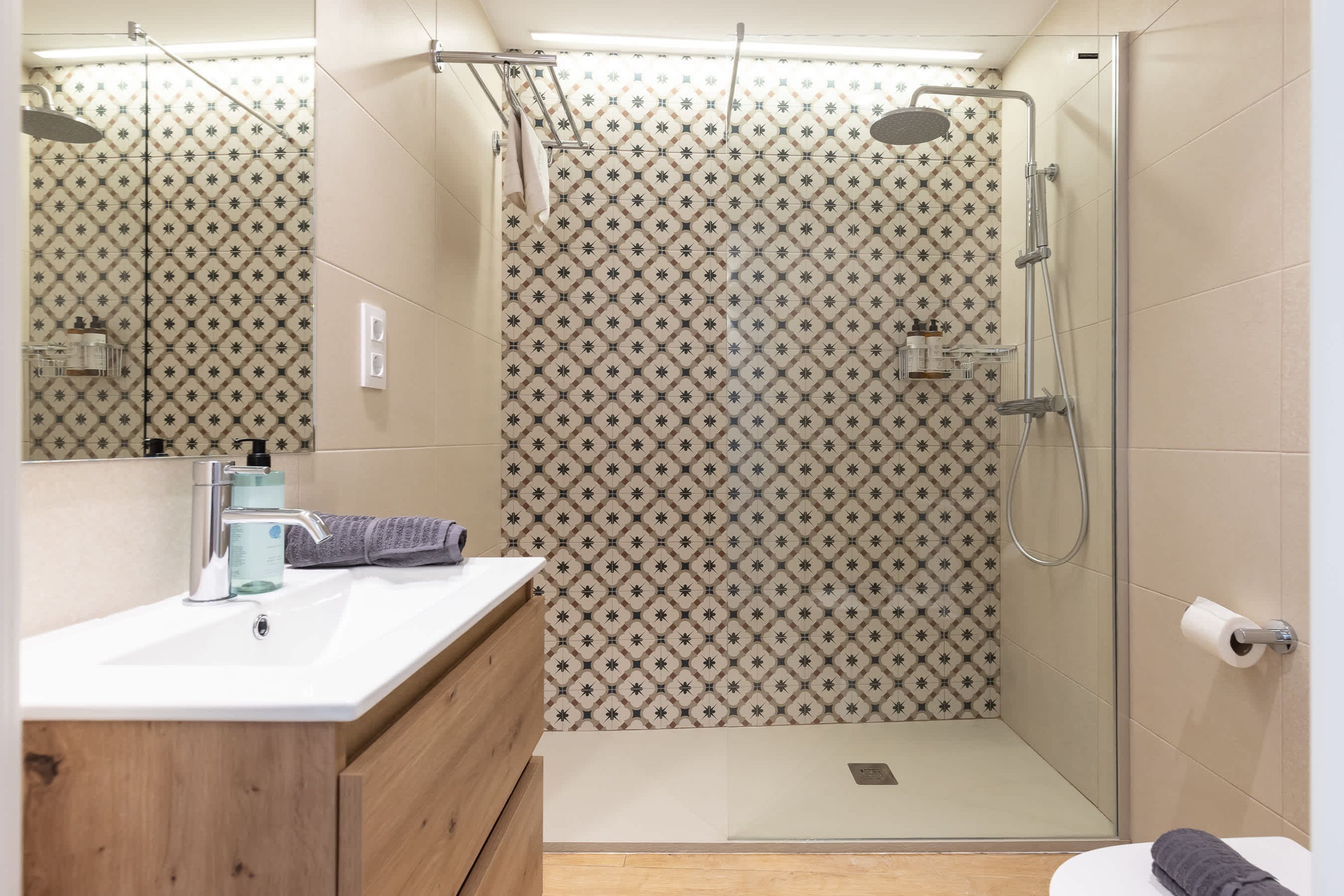 A modern bathroom with a shower, toilet, and sink.