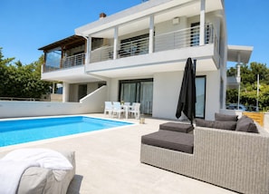 A modern two-story house with a swimming pool, outdoor seating, and a covered patio area. - Heaven Horizon Villa - Ethereal and Blissful Gem (Pangaio)