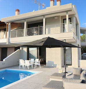 A modern two-story house with a swimming pool, outdoor seating, and a balcony. - Heaven Horizon Villa - Ethereal and Blissful Gem (Pangaio)