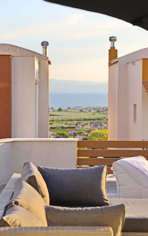 A balcony with a view of a landscape, including buildings and greenery. - Heaven Horizon Villa - Ethereal and Blissful Gem (Pangaio)