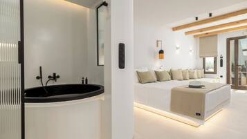 A modern bathroom with a freestanding bathtub and a large mirror.