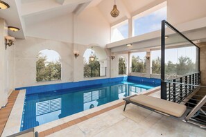 A swimming pool with a glass balustrade, a lounge chair, and a staircase leading to an upper level. - Mia Riverside Villa D7 with 9 bedrooms (Ho Chi Minh City)