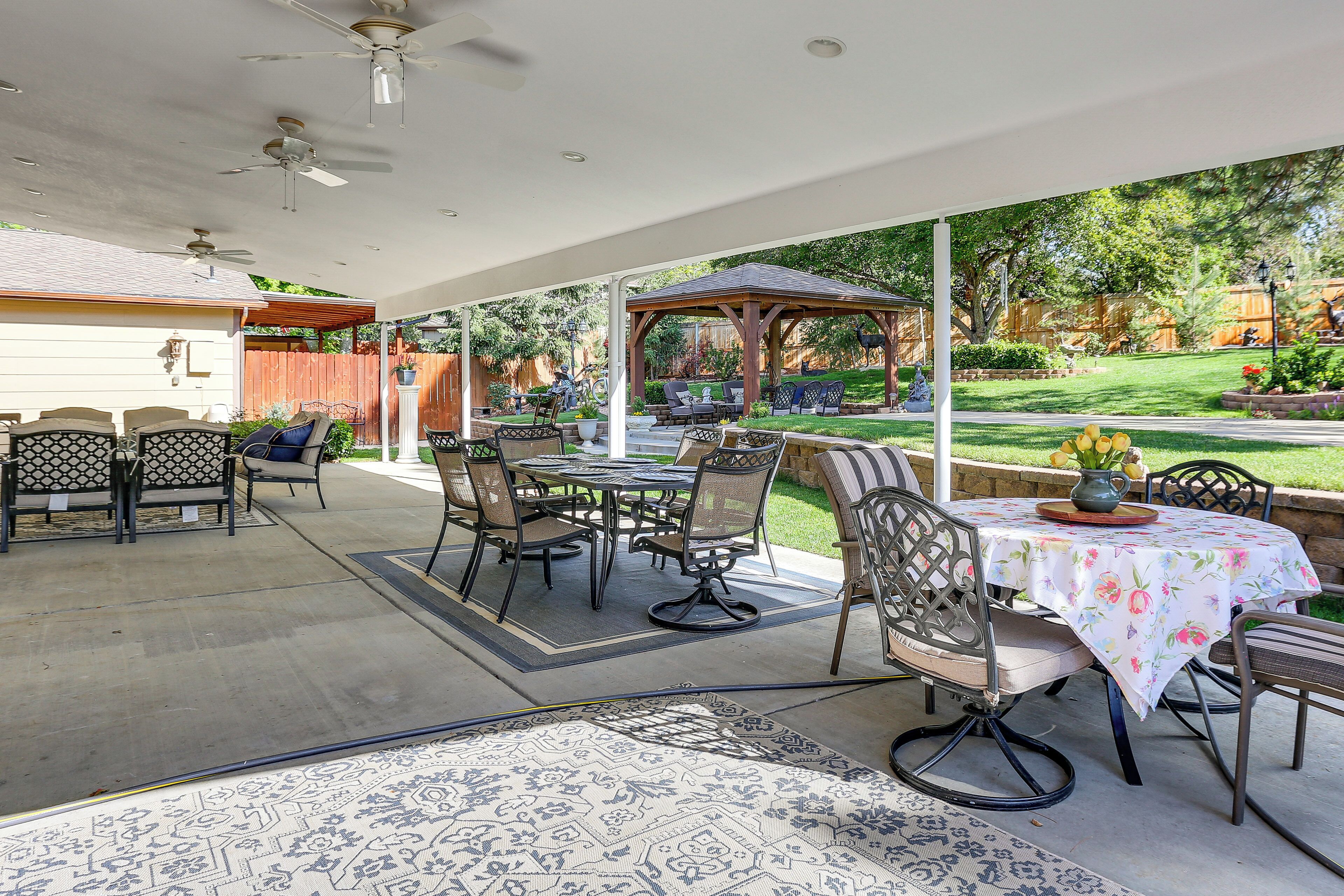 A covered patio with outdoor furniture, a gazebo, and a view of the backyard.