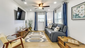 A living room with a sofa, armchair, wooden coffee table, and a ceiling fan. - Work & Play in Palmetto! Pet-friendly Home w/ Yard (Palmetto)