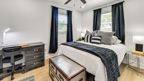 A bedroom with a bed, desk, chair, dresser, and a ceiling fan. - Work & Play in Palmetto! Pet-friendly Home w/ Yard (Palmetto)