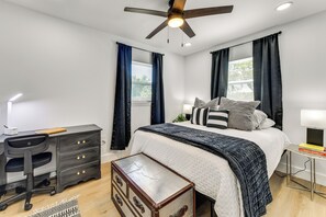 A bedroom with a bed, desk, chair, dresser, and a ceiling fan. - Work & Play in Palmetto! Pet-friendly Home w/ Yard (Palmetto)