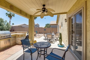 An outdoor patio with a ceiling fan, a grill, and patio furniture. - San Tan Valley Home w/ Patio in Johnson Ranch! (San Tan Valley)