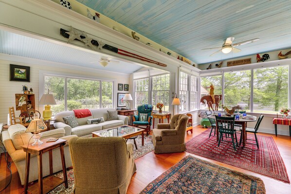 A spacious living room with a high ceiling, large windows, and a variety of seating arrangements. - Private, Exclusive, Historic Pocomoke River Estate (Pocomoke City)