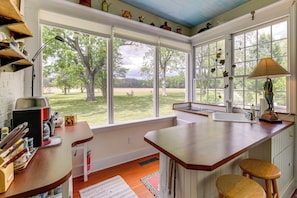 A kitchen with a large window, a sink, and a countertop. - Private, Exclusive, Historic Pocomoke River Estate (Pocomoke City)