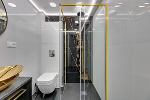 A modern bathroom with a glass-enclosed shower, a toilet, and a vanity with a gold bowl. - Comfy Sopot Family House  (Sopot)