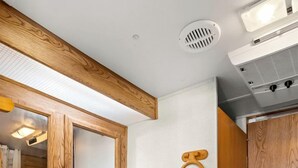 A bathroom with a wooden vanity, a mirror, a sink, and a towel rack. - Starry Nights and Firelit Memories in Boerne, TX (Boerne)