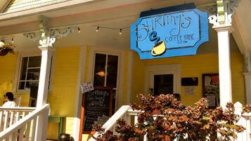 A yellow building with a blue sign reading 'Stirling's Coffee House' and a chalkboard menu.