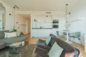 Apartment (1 Bedroom) | Living area | 32-inch TV with cable channels - Skyline Lake Apartment (Como)