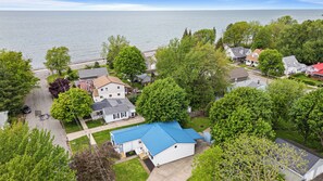 A residential area with houses, a dock, and a large body of water.