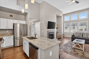 A modern kitchen with stainless steel appliances, a granite countertop, and a built-in dishwasher. - Scottsdale Basecamp With Prime Golf Access 2 Bedroom Condo (Scottsdale)
