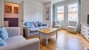 Een moderne woonkamer met een bank, een salontafel en een stoel.