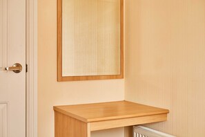 A wooden door with a mirror above it and a small wooden shelf below. - Host Stay Pine View (Windermere)