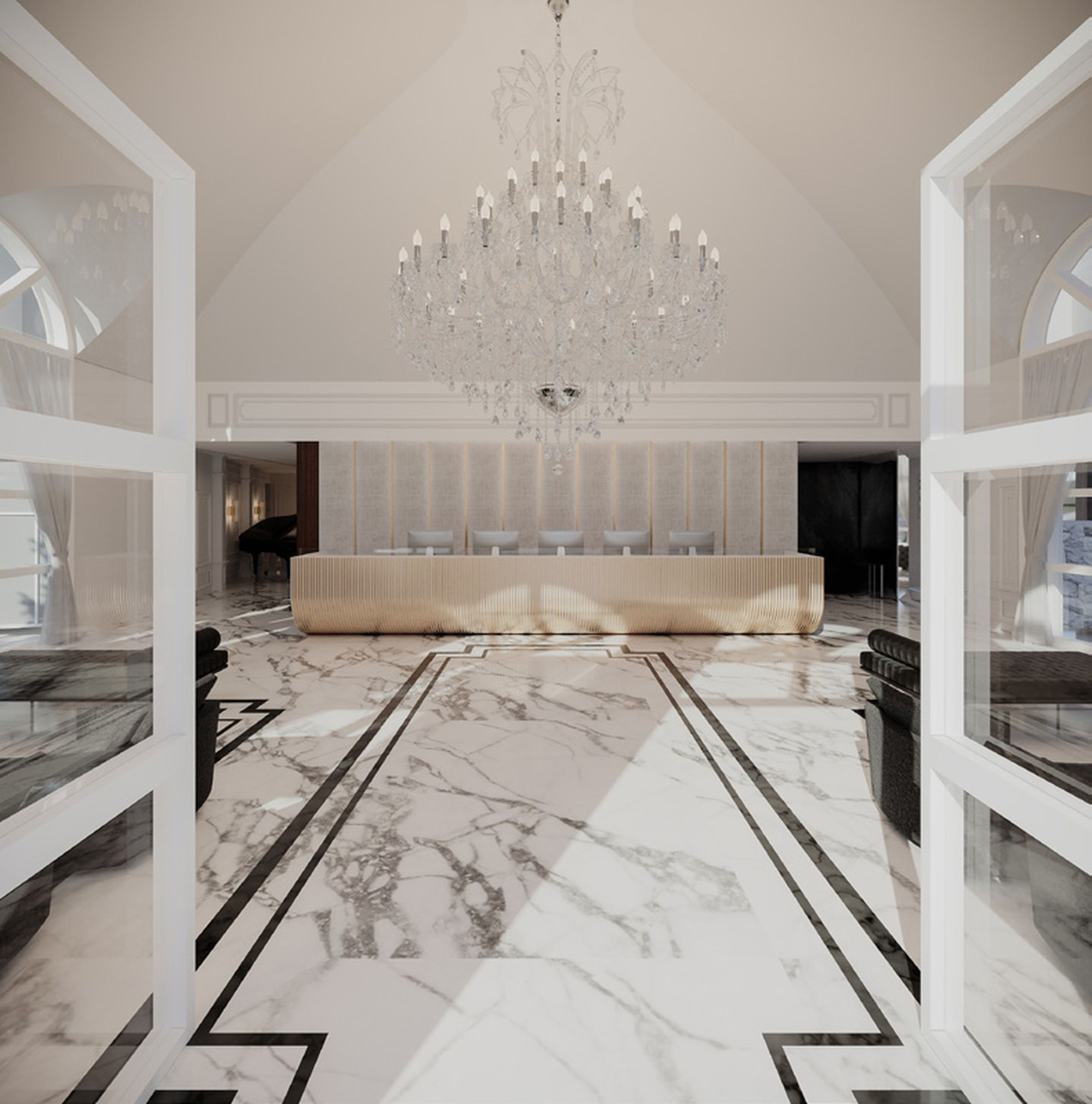 Um hall amplo com piso de mármore, uma grande área de estar e um imponente candelabro.
