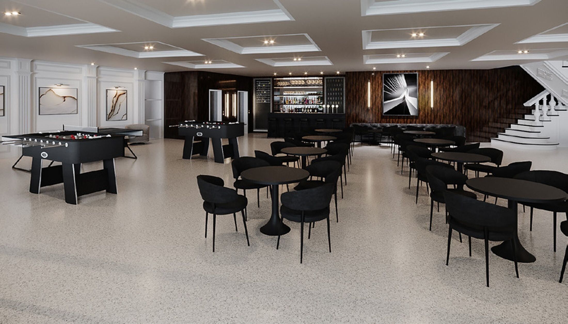 Un espace intérieur moderne doté d’un baby-foot, de plusieurs coins salon et d’un bar.