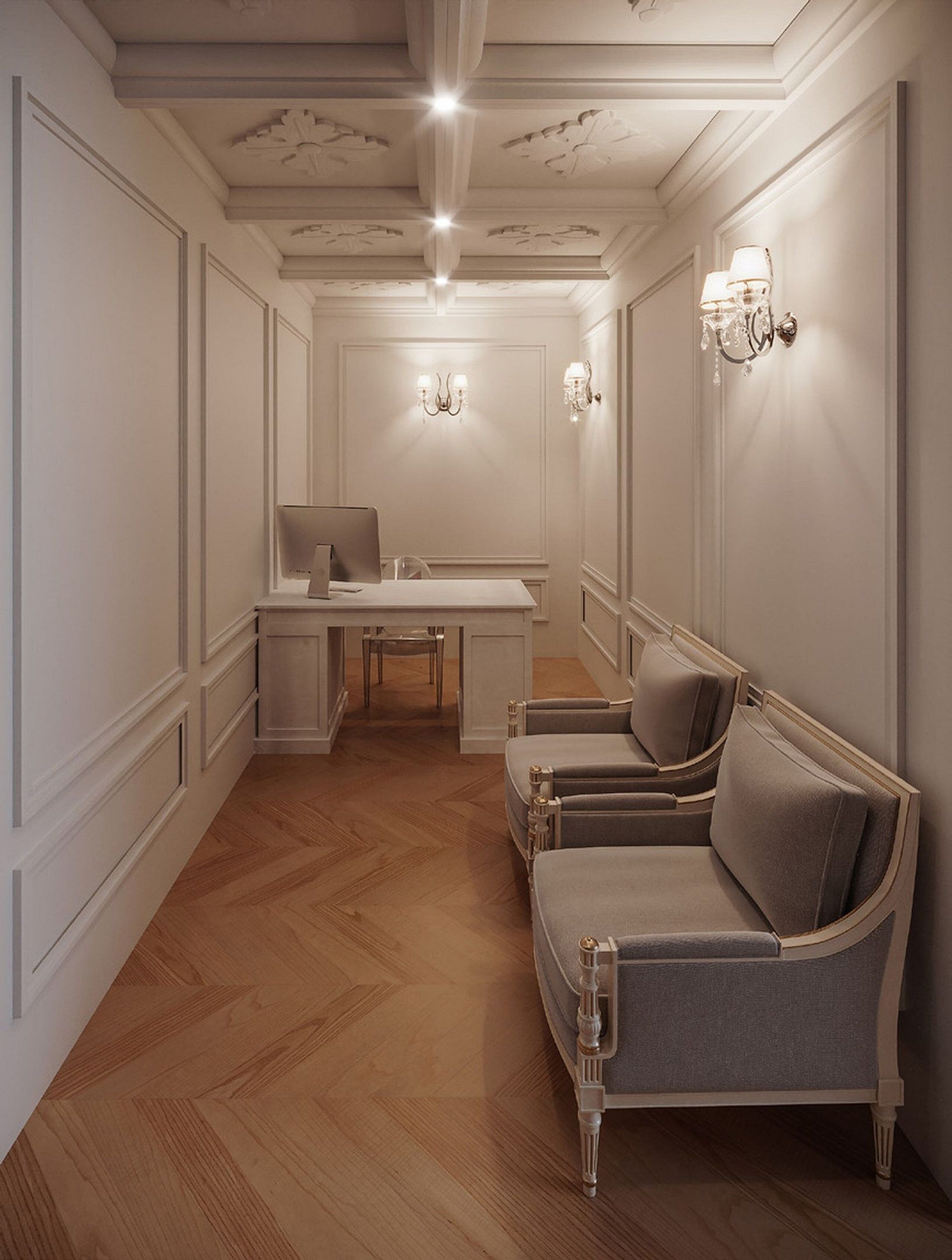 Une pièce dotée d’un parquet en bois disposé en motif à chevrons, d’un bureau blanc avec une chaise, d’un canapé et d’appliques murales.