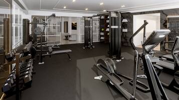 A modern gym with various exercise equipment, including treadmills and weight machines.