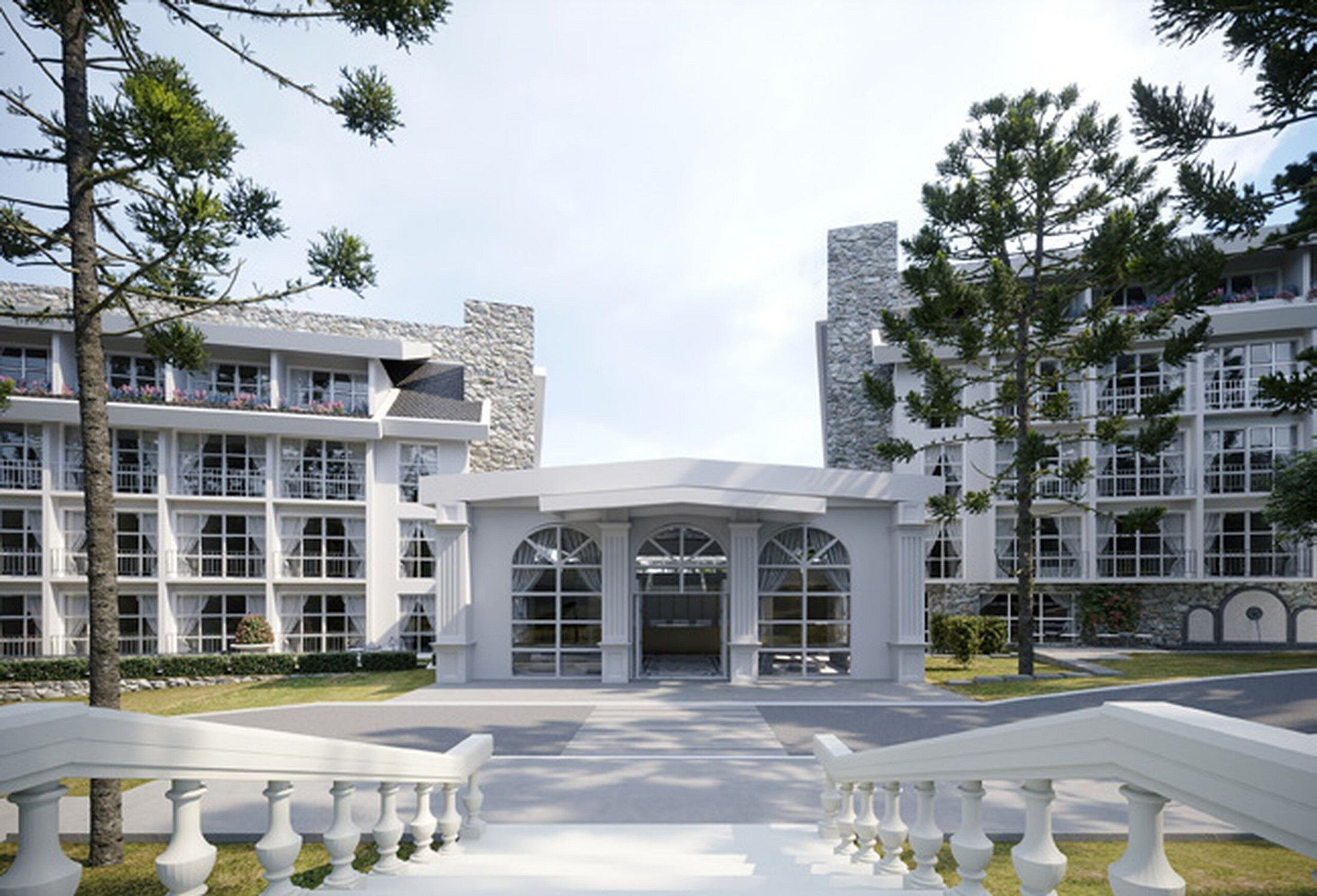 A modern hotel with a central entrance, multiple floors, and a stone facade.