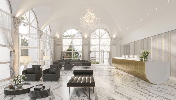 A spacious lobby with a marble floor, seating area, and a reception desk.