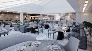 En rymlig restaurang med högt i tak, modern inredning och stora fönster.