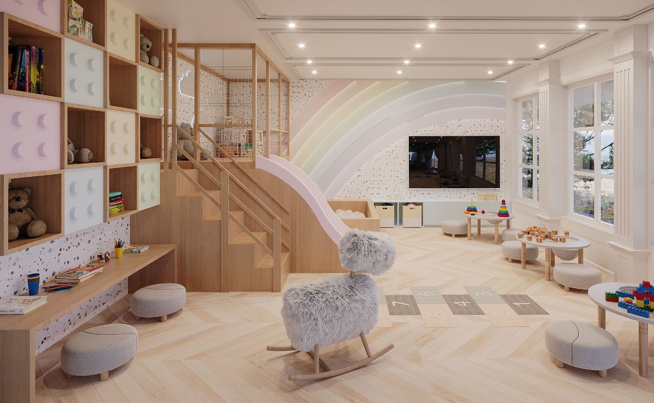 Une salle de jeux pour enfants avec un escalier en bois, une télévision et divers jouets.