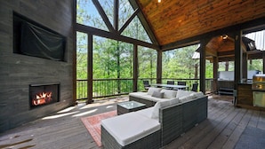 A covered outdoor area with a fireplace, seating, and a kitchen area. - Happy Heart Hideaway - Amazing Outdoor Space (Broken Bow)