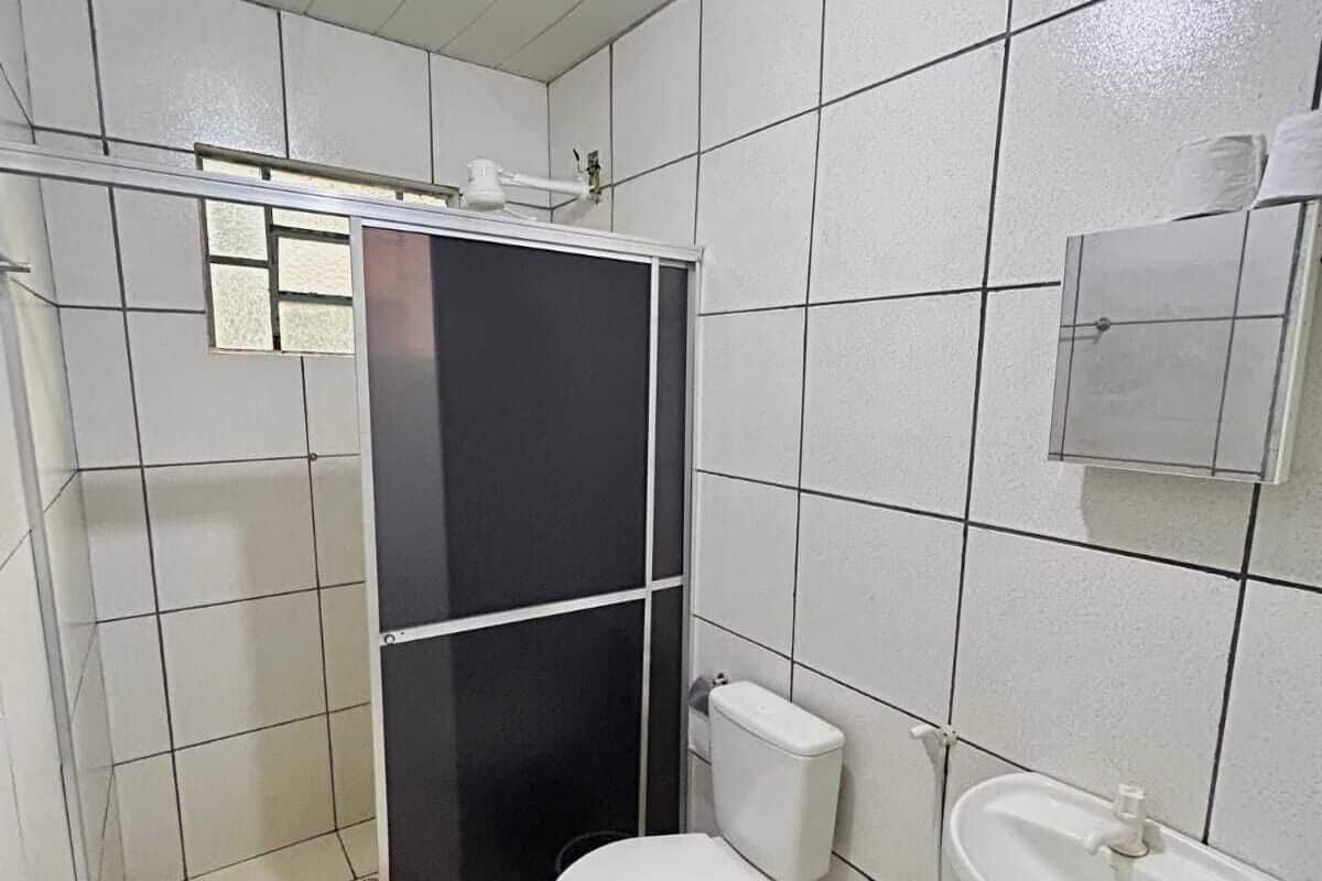 A bathroom with a shower, toilet, and sink.