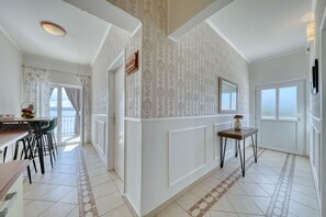 A modern kitchen with a dining area, a large window, and a view of the outdoors. - Apartment Laura 2 by the Sea (Maslenica)