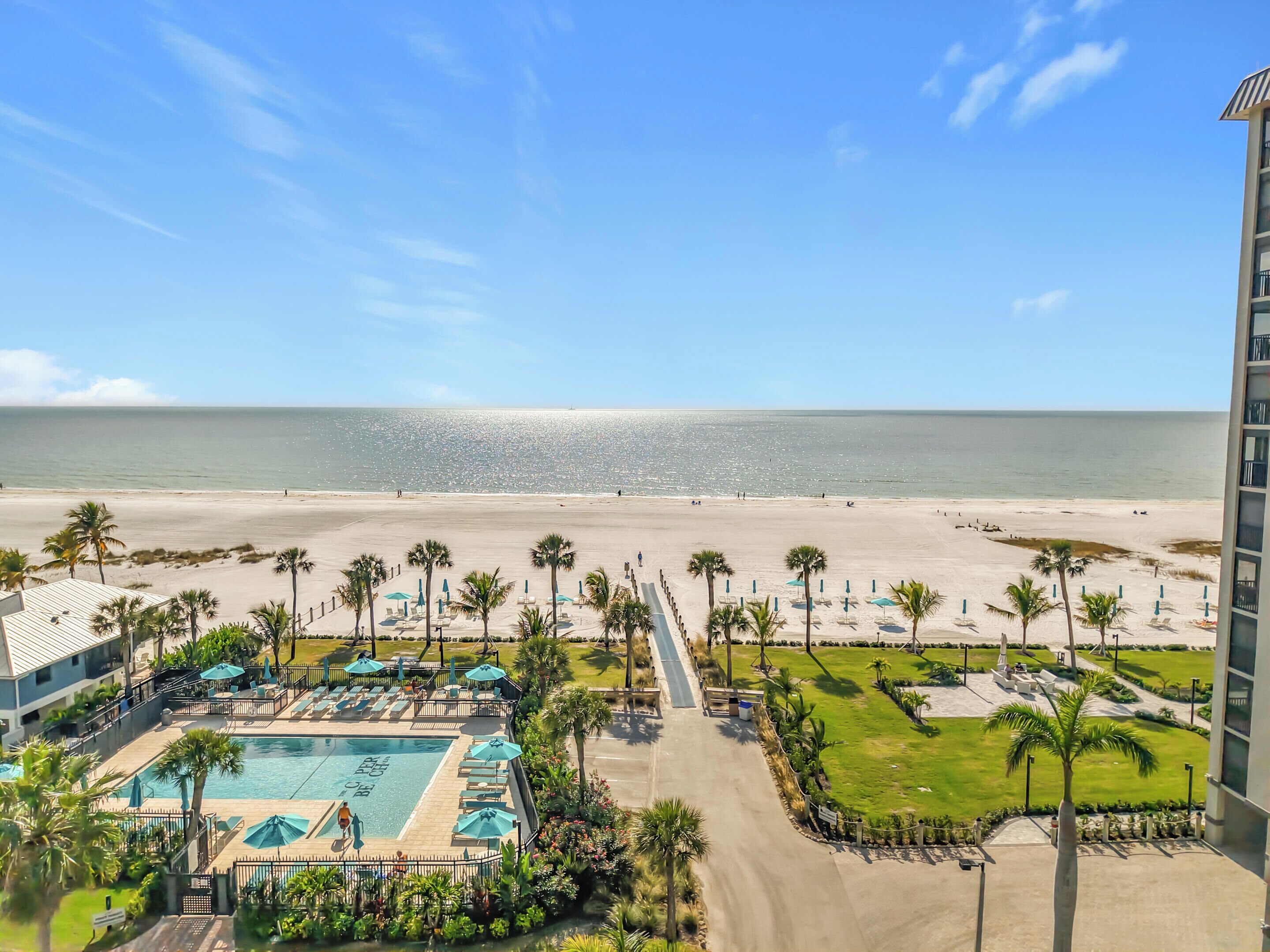 A resort with a pool, beach, and ocean view.